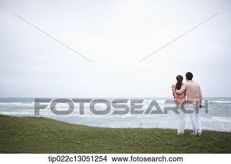 Picture - a man and a woman on a grass field. Fotosearch