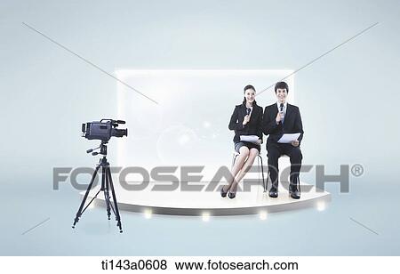 Stock Photo - a man and a woman sitting on a TV set. Fotosearch