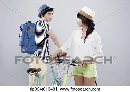 Stock Image - a man and a woman with bikes. Fotosearch