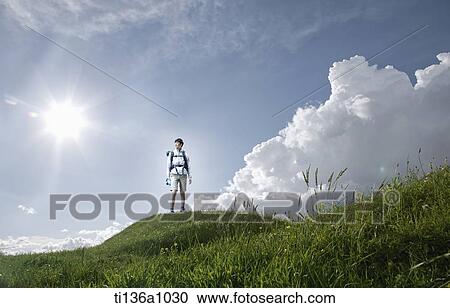 a man hiking on a grass field View Large Photo Image Stock Image - a man hiking on a grass field. Fotosearch