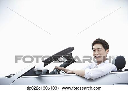 a man in a convertible car View Large Photo Image Stock Photo - a man in a convertible car. Fotosearch