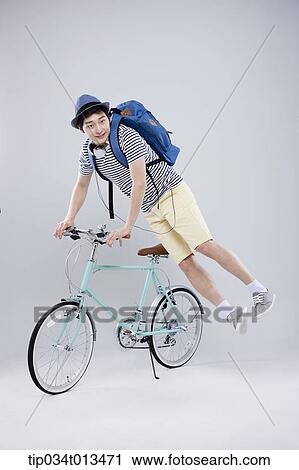 Stock Image - a man playing on a bike. Fotosearch