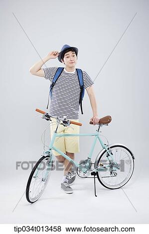 Stock Photo - a man posing with a bike. Fotosearch