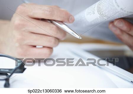 Stock Photograph - a man reading a newspaper. Fotosearch