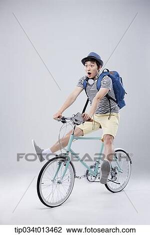 Stock Image - a man riding a bike. Fotosearch