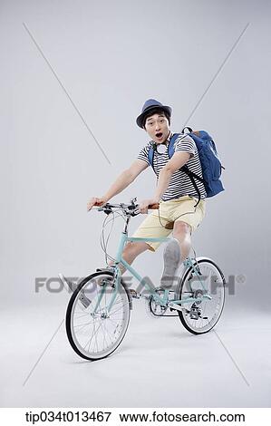 Stock Photo - a man riding a bike. Fotosearch