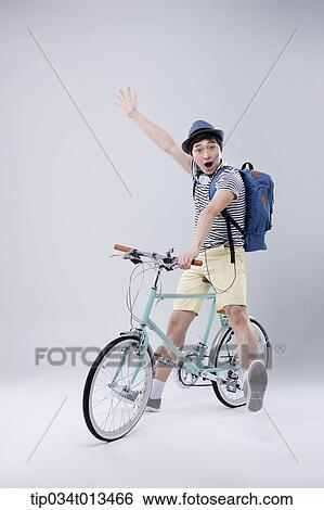 a man riding a bike waving View Large Photo Image Stock Photograph - a man riding a bike waving. Fotosearch