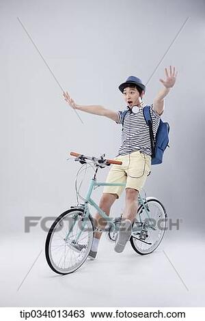 a man riding a bike with hands off View Large Photo Image Stock Image - a man riding a bike with hands off. Fotosearch