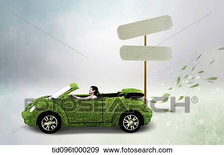 Stock Photo - a man riding a car made out of grass. Fotosearch