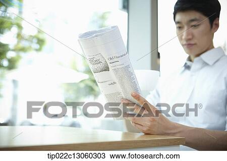 a man with a white shirt reading a newspaper View Large Photo Image Stock Image - a man with a white shirt reading a newspaper. Fotosearch