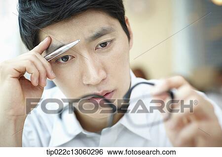 Stock Photograph - a man with a white shirt thinking. Fotosearch