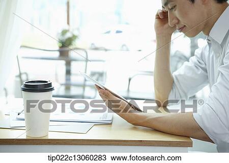 a man working in a coffee shop View Large Photo Image Stock Image - a man working in a coffee shop. Fotosearch