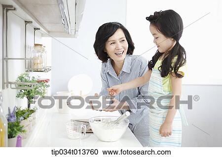 a mother and a daughter cooking together View Large Photo Image Stock Image - a mother and a daughter cooking together. Fotosearch