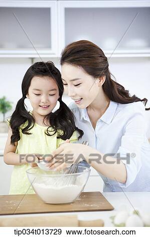 a mother and a daughter cooking together View Large Photo Image Stock Photo - a mother and a daughter cooking together. Fotosearch