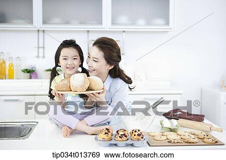 a mother and a daughter with a board of bread View Large Photo Image Stock Photo - a mother and a daughter with a board of bread. Fotosearch