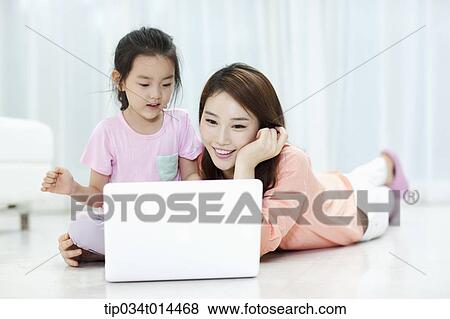 a mother and daughter using laptop together View Large Photo Image Stock Photo - a mother and daughter using laptop together. Fotosearch