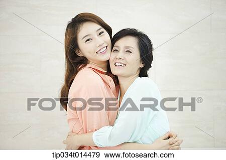 a mother hugging with grown up daughter View Large Photo Image Stock Photo - a mother hugging with grown up daughter. Fotosearch