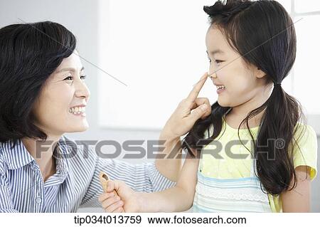 a mother playing with daughter while cooking View Large Photo Image Stock Photo - a mother playing with daughter while cooking. Fotosearch