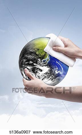 a pair of hands cleaning the globe View Large Photo Image Stock Photo - a pair of hands cleaning the globe. Fotosearch