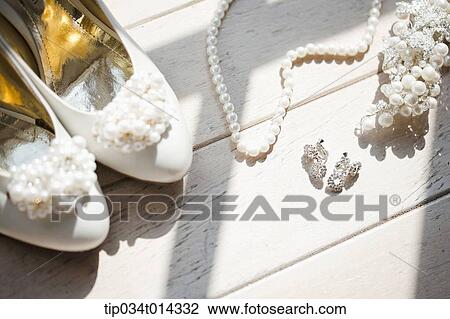 Stock Image - a pair of heels next to necklace. Fotosearch
