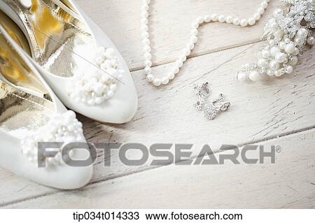 Stock Image - a pair of heels next to necklace. Fotosearch