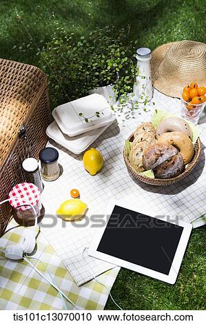 a picnic set and a tablet spread out on a sheet View Large Photo Image Stock Image - a picnic set and a tablet spread out on a sheet. Fotosearch