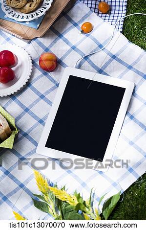a picnic set and a tablet spread out on a sheet View Large Photo Image Stock Image - a picnic set and a tablet spread out on a sheet. Fotosearch