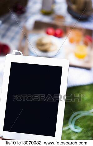 a picnic set and a tablet spread out on a sheet View Large Photo Image Stock Image - a picnic set and a tablet spread out on a sheet. Fotosearch