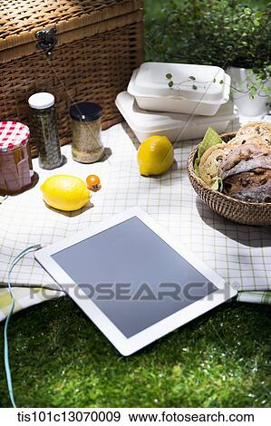 a picnic set and a tablet spread out on a sheet View Large Photo Image Stock Photo - a picnic set and a tablet spread out on a sheet. Fotosearch