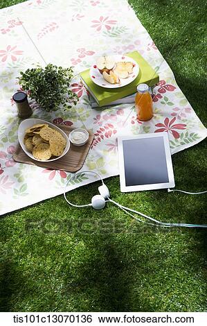 a picnic set and a tablet spread out on a sheet View Large Photo Image Stock Photograph - a picnic set and a tablet spread out on a sheet. Fotosearch