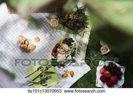 Stock Image - a picnic set spread out on a sheet. Fotosearch