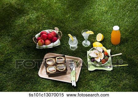 a picnic set spread out on the grass View Large Photo Image Stock Photography - a picnic set spread out on the grass. Fotosearch