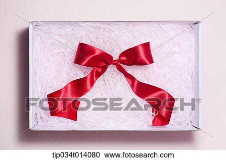 Stock Image - a ribbon inside a box filled with flowers . Fotosearch