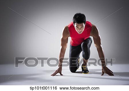 Stock Photograph - a runner in starting position. Fotosearch