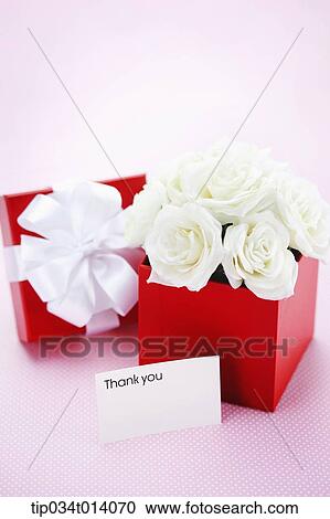 Stock Image - a thank you note in front of box filled with flowers. Fotosearch