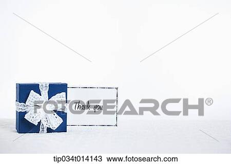 Stock Image - a thank you note next to a gift box. Fotosearch