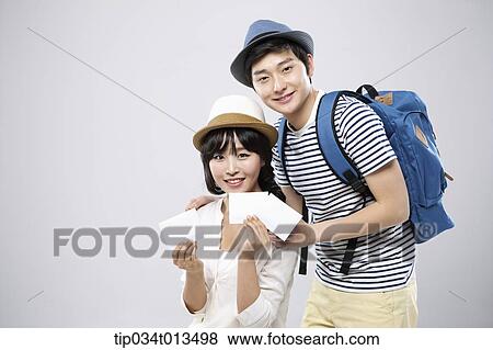 a traveling couple holding small notes View Large Photo Image Stock Photo - a traveling couple holding small notes. Fotosearch