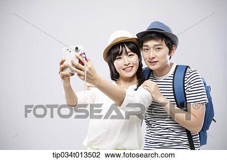 a travelling couple taking a picture together View Large Photo Image Stock Image - a travelling couple taking a picture together. Fotosearch