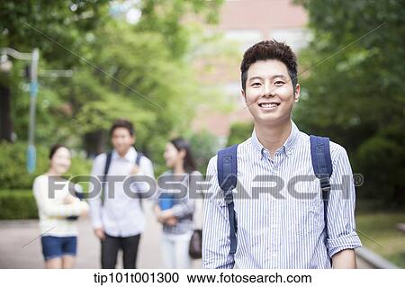 a university student standing in the campus smiling View Large Photo Image Stock Image - a university student standing in the campus smiling . Fotosearch