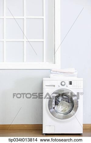 Picture - a washing machine in the house . Fotosearch