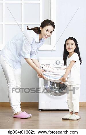 Stock Photography - a woman and a daughter with folded towers. Fotosearch
