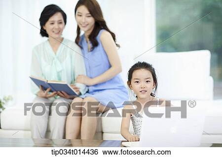 a woman and daughter watching kid using laptop View Large Photo Image Stock Photograph - a woman and daughter watching kid using laptop. Fotosearch