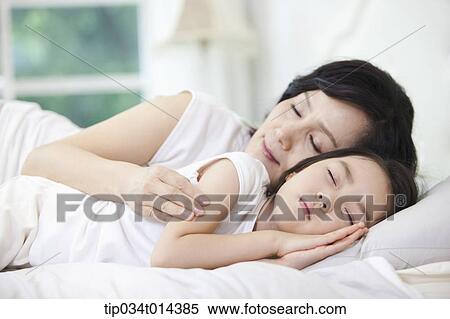 a woman and granddaughter sleeping on a bed View Large Photo Image Stock Photography - a woman and granddaughter sleeping on a bed. Fotosearch