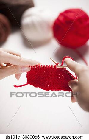 Stock Photograph - a woman doing knit stitches . Fotosearch