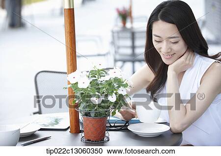 Stock Image - a woman drinking coffee. Fotosearch