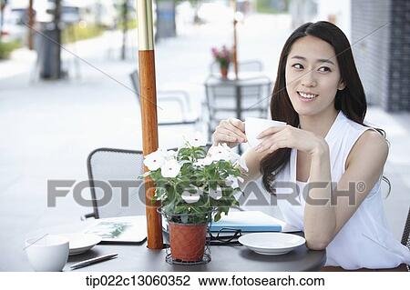 Stock Image - a woman drinking coffee. Fotosearch