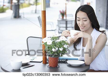 a woman drinking coffee View Large Photo Image Stock Image - a woman drinking coffee. Fotosearch