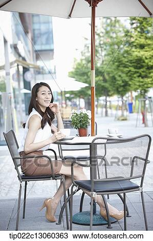Stock Image - a woman drinking coffee. Fotosearch