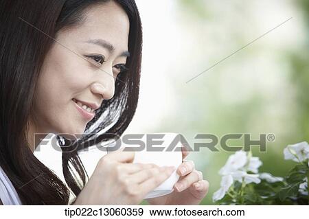 Stock Photo - a woman drinking coffee. Fotosearch
