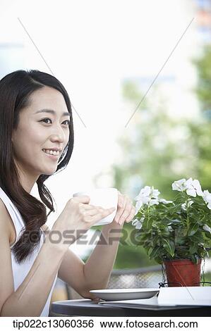 a woman drinking coffee View Large Photo Image Stock Photograph - a woman drinking coffee. Fotosearch